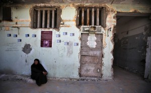 A Palestinian woman sits at Saraya prison that had been used by Israeli security services to keep Palestinian prisoners during Israel's occupation of Gaza Strip