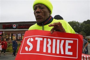 A man participates in a march outside a Wendy's restaurant in Boston