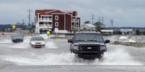 Vehicles make their way through high water as they drive after hurricane Arthur passed through in Nags Head