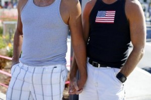 A gay couple holds hands during a rally in support of the United States Supreme Court decision on marriage rights in San Diego