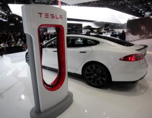 File of a Tesla S electric car and a charging station are displayed during the press preview day of the North American International Auto Show in Detroit