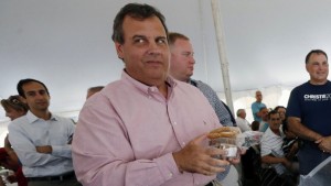 Republican presidential candidate, New Jersey Gov. Chris Christie holds pastries he was offered while campaigning during a Greek festival in Manchester, N.H., Saturday, Aug. 29, 2015. (AP Photo/Michael Dwyer)